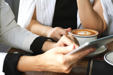 Coffee break while discussing business plan at cafe.