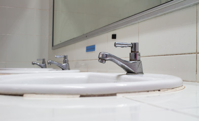 Bathroom at office.Handbasin and mirror in toilet
