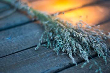 Sheaf of hay on a wooden background.