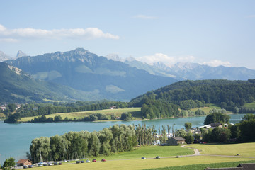 Fototapeta na wymiar A View of Lac de la Gruyère (Lake of Gruyère) in Switzerland on a Summer Day