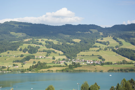 A View of the Houses Overlooking Lac de la Gruyère (Lake of Gruyère) in Switzerland on a Summer Day