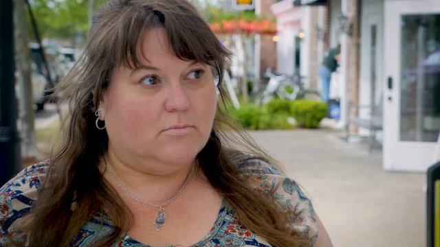 Surprised woman expressing her emotions on the urban city sidewalk