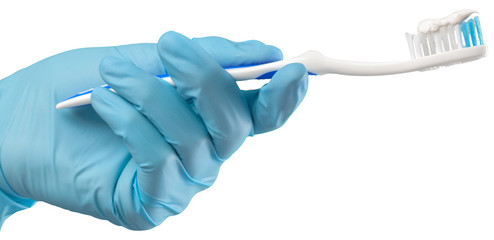 Toothbrush in the gloved hand