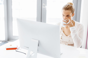 Attractive office worker sitting at desk