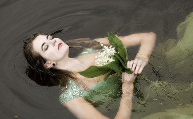 The woman blindly, floats down the river, meditation in water