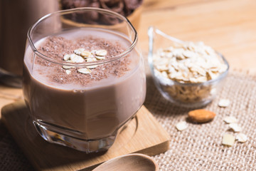 Glass of chocolate milk on table