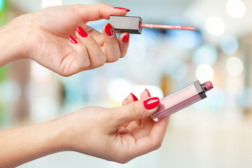 Woman's hand holds lipstick