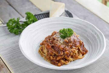 Spaghetti bolognese with cheese and pasley