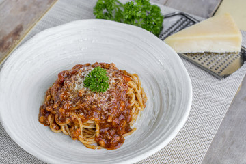 Spaghetti bolognese with cheese and pasley