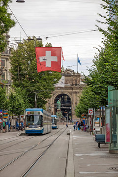 Zurich shopping street Bahnhofstrasse with tram and swiss flag