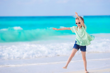 Adorable little girl at beach during summer vacation