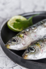 Fresh raw fish on wooden board. Background. From above
