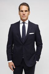 man with dark suit and dark tie