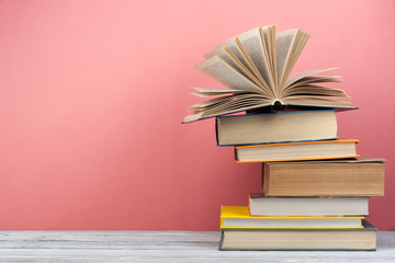 Stack of colorful books. Education background. Back to school. Book, hardback colorful books on wooden table. Education business concept. Copy space for text.