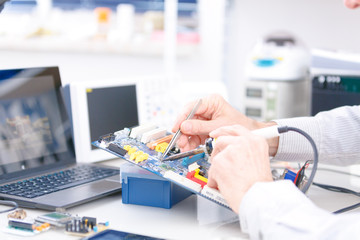 repair electronics device in laboratory