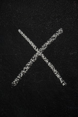Letter X drawn with white chalk on blackboard. Education, school concept