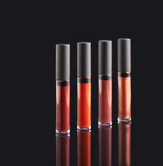 Obraz premium Palette of liquid lipstick on black background