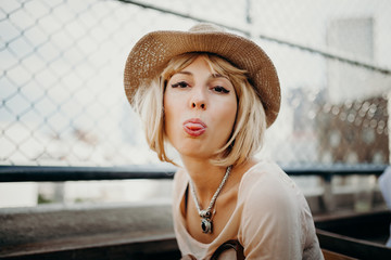 Cute woman sticking out her tongue in a funny way.