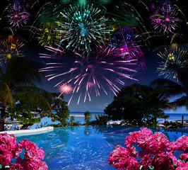Bright festive fireworks over the sea and the beach