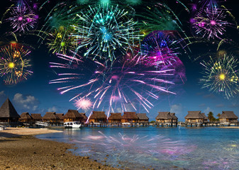 Bright festive fireworks over the sea and the beach