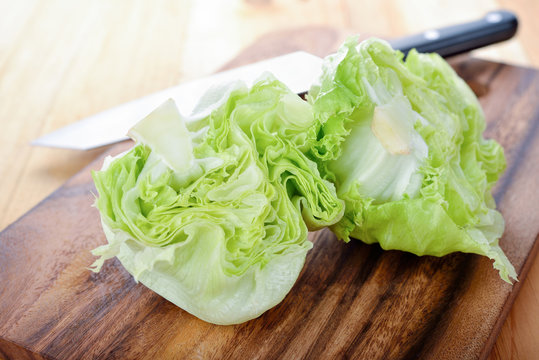 fresh green iceberg lettuce on cutting board