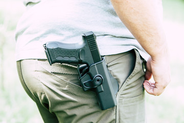 Pistol in the holster. The shooter trains. Is preparing to shoot at the target