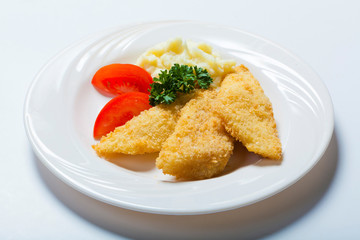 fish in breadcrumbs with garlic sauce on the white background