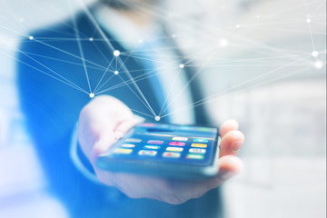 Hand of a businessman holding smartphone with operating system screen and network connection