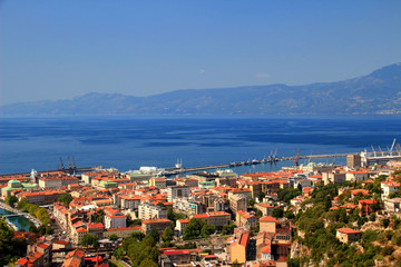 Fototapeta na wymiar Sunny cityscape of Rijeka, the largest port of Croatia, with red rooftops of city center and the blue water of Kvarner Gulf, Adriatic Sea, in the background Ucka range, Istrian peninsula