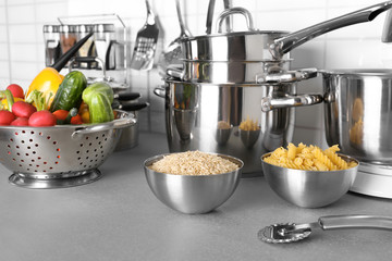 Utensils and vegetables for cooking classes on table in kitchen