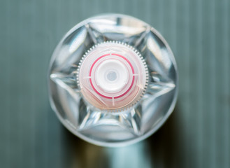 clear plastic bottle with a red and white cap