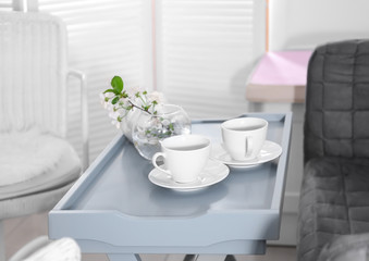 Fototapeta na wymiar Tea set on table in modern veranda interior