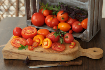 Tomatoes and basil on a wooden board in a rustic style