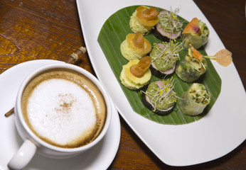authentic Bali snack and cup of coffee with milk..