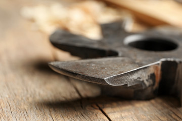 Milling cutter on wooden table in carpenter's workshop, closeup