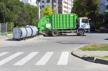 garbage truck with recycle bin in the city
