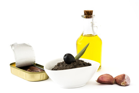 Black olive tapenade with anchovies, garlic and olive oil isolated on white background

