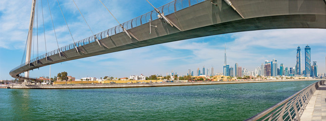 Dubai - The skyline with the bridge over the new Canal and Downtown.