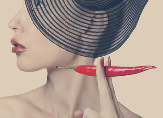 Portrait of the woman with red burning pepper, retro effect