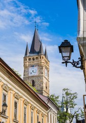Fototapeta na wymiar Old church tower with clock and street detail - Romania Transylvania