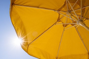 Yellow umbrella and rays of sun