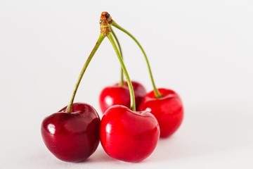 Ripe cherries on a white background