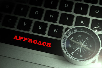 Compass on the black keybord with planning,strategic conceptual text. low light