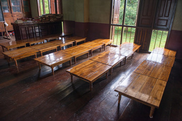 Historic old education room with brown floor and table in Myanmar