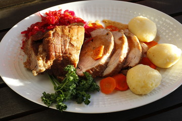 roast meat with dumplings, carrots and red cabbage