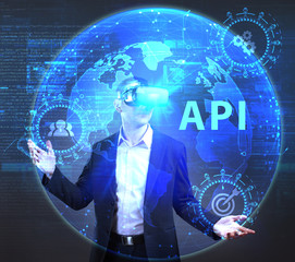 The concept of business, technology, the Internet and the network. A young entrepreneur working on a virtual screen of the future and sees the inscription: API