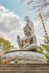 Stainless sitting buddha in Kanjanaburi, Thailand