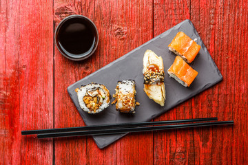 Photo of rolls with chopsticks