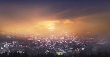 Fototapeta premium Ukraine. Downtown of Skhodnits. Architectural monument . red rooftops . fog in mountains . Wonderful little village