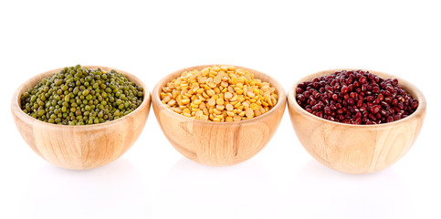 green beans, soy beans, red beans, wooden bowls on white background